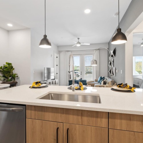 a kitchen with a sink and a living room