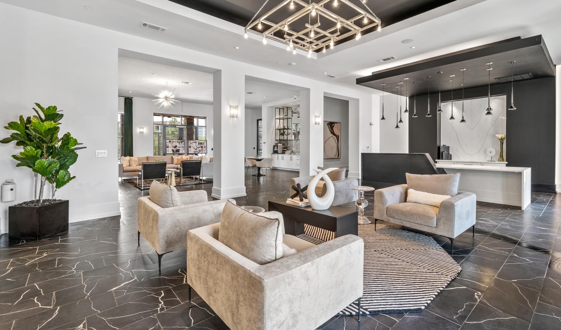 a clubroom with a front desk, tables and chairs