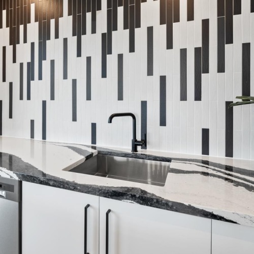 a kitchen sink with a plant