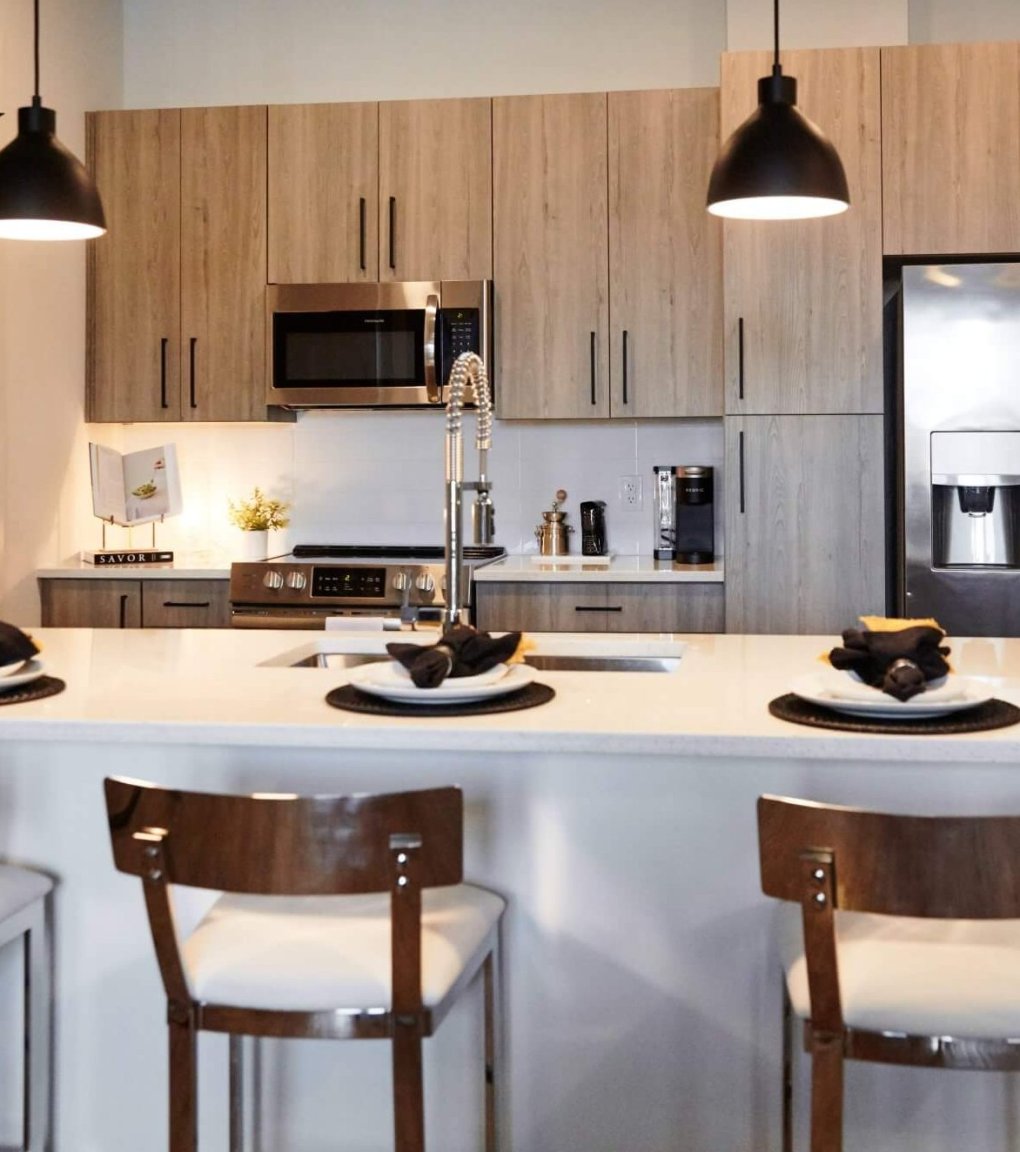 open kitchen with breakfast bar and quartz countertops